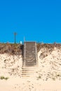 Wooden old stairs going up built on sand dunes Royalty Free Stock Photo