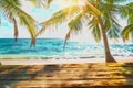 Wooden old table of free space for your decoration. Summer beach landscape with palms and ocean. Summer suny day and sun light.