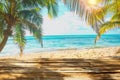 Wooden old table of free space for your decoration. Summer beach landscape with palms and ocean. Summer suny day and sun light.