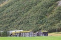 Wooden old traditional nordic houses with grass roofs in scenic landscape Royalty Free Stock Photo