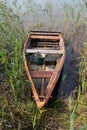 Wooden old used fishing boat on lake in autumn Royalty Free Stock Photo