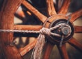 A wooden old wheel from a cart that was used for harvesting in the village. Transport of the past. Agriculture and the peasantry