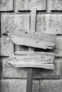 Wooden, old, white arrows on a concrete wall. White and black background