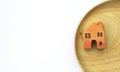 Wooden orange miniature house on wooden tray