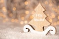 Wooden ornament cutout in the shape of a pine tree with copy space - translation text Feliz Navidad - merry christmas