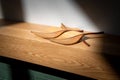 Wooden ornamental leaves laid out on an American Oak Mantle piece above fireplace