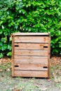 Wooden outdoor composter bin for recycling home kitchen and garden organic waste Royalty Free Stock Photo