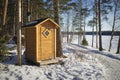 A wooden outhouse toilet in springtime