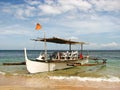 Wooden Outrigger Boat on a Beach Shore Royalty Free Stock Photo