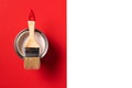 Wooden paint brush, open paint can on trendy red and white background. Top view, copy space. Appartment renovation Royalty Free Stock Photo