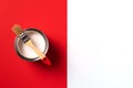 Wooden paint brush, open paint can on trendy red and white background. Top view, copy space. Appartment renovation Royalty Free Stock Photo