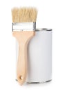 Wooden paint brush with paint tin close-up on white background. Royalty Free Stock Photo