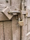 wooden painted door of brown color closed on two locks hanging Royalty Free Stock Photo
