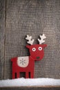 Wooden painted reindeer in the snow Royalty Free Stock Photo