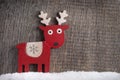 Wooden painted reindeer in the snow Royalty Free Stock Photo