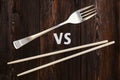 Wooden pairs of chopsticks vs fork. Abstract conceptual image Royalty Free Stock Photo