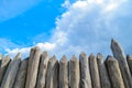 Wooden palisade on the background of blue sky Royalty Free Stock Photo