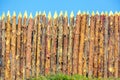 A wooden palisade made of logs sharpened on a sharp Royalty Free Stock Photo