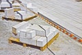 Wooden pallet of new sandstone slabs ready to be mounted in a new pavement in a urban construction site Royalty Free Stock Photo