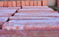 wooden pallet plenty of old stacked red bricks. The bricks are ordered in many rows Royalty Free Stock Photo