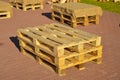 Wooden pallets are placed on the track in pairs to be used as benches.