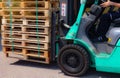 Wooden pallets stack at the freight cargo warehouse for transportation and logistics industrial, Driver forklift loading