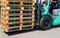 Wooden pallets stack at the freight cargo warehouse for transportation and logistics industrial, Driver forklift loading