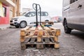 Wooden pallets stacked on a pallet truck for loading, unloading, and transporting Royalty Free Stock Photo