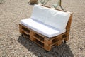 Wooden pallets and white cushions make garden wood lounge chair in home garden outdoor Royalty Free Stock Photo