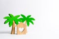 Wooden palm tree and house with hearts on a white background. Rental homes and properties in the resort. Romantic travel. Royalty Free Stock Photo
