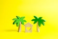 Wooden palm tree and house with hearts on an yellow background. Rental homes and properties in the resort. Romantic travel. Royalty Free Stock Photo