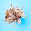 Wooden and paper utensil in a cup on blue background, zero waste or plastic free concept, top view, square format Royalty Free Stock Photo