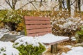 Wooden park bench covered with snow Royalty Free Stock Photo