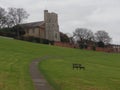 Wooden park bench in a field overlooking the church
