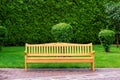 Wooden park bench with sidewalk and green lawn. Royalty Free Stock Photo