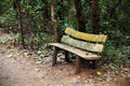 Wooden park bench, sitting area in the woods Royalty Free Stock Photo