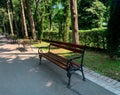 Wooden park benches in the alley of public garden