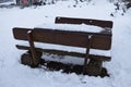 wooden park benches under snow,