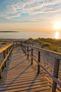 Wooden path at Baltic sea over sand dunes with ocean view, sunset summer evening Royalty Free Stock Photo