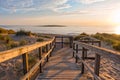 Wooden path at Baltic sea over sand dunes with ocean view, sunset summer evening Royalty Free Stock Photo