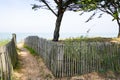 Wooden path coast access with sand beach entrance to ocean atlantic sea in isle oleron island france Royalty Free Stock Photo