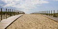 Wooden path coast access with sand beach waves entrance to ocean atlantic sea in cap-ferret france Royalty Free Stock Photo