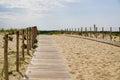 Wooden path coast access with sand beach waves entrance to ocean atlantic sea Royalty Free Stock Photo
