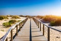 Wooden path at Costa Nova d'Aveiro, Portugal, over sand dunes with ocean view, summer evening. Wooden footbridge of Costa Nova Royalty Free Stock Photo