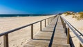 Wooden path at Costa Nova d'Aveiro, Portugal, over sand dunes with ocean view, summer evening. Wooden footbridge of Costa Nova Royalty Free Stock Photo