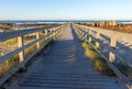 Wooden path with fence to the beach. Walkway on seashore in the morning. Atlantic Ocean coast in Portugal. Royalty Free Stock Photo