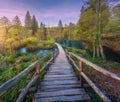 Wooden path in green forest in Plitvice Lakes, Croatia at sunset Royalty Free Stock Photo