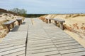 Wooden path leading through dunes at Nagliai nature reserve near Nida Royalty Free Stock Photo