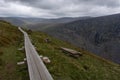 Wooden path leading through foggy mountain landscape. Wicklow mountains, Ireland Royalty Free Stock Photo