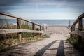 wooden path leads over the dunes to the Baltic Sea beach Royalty Free Stock Photo